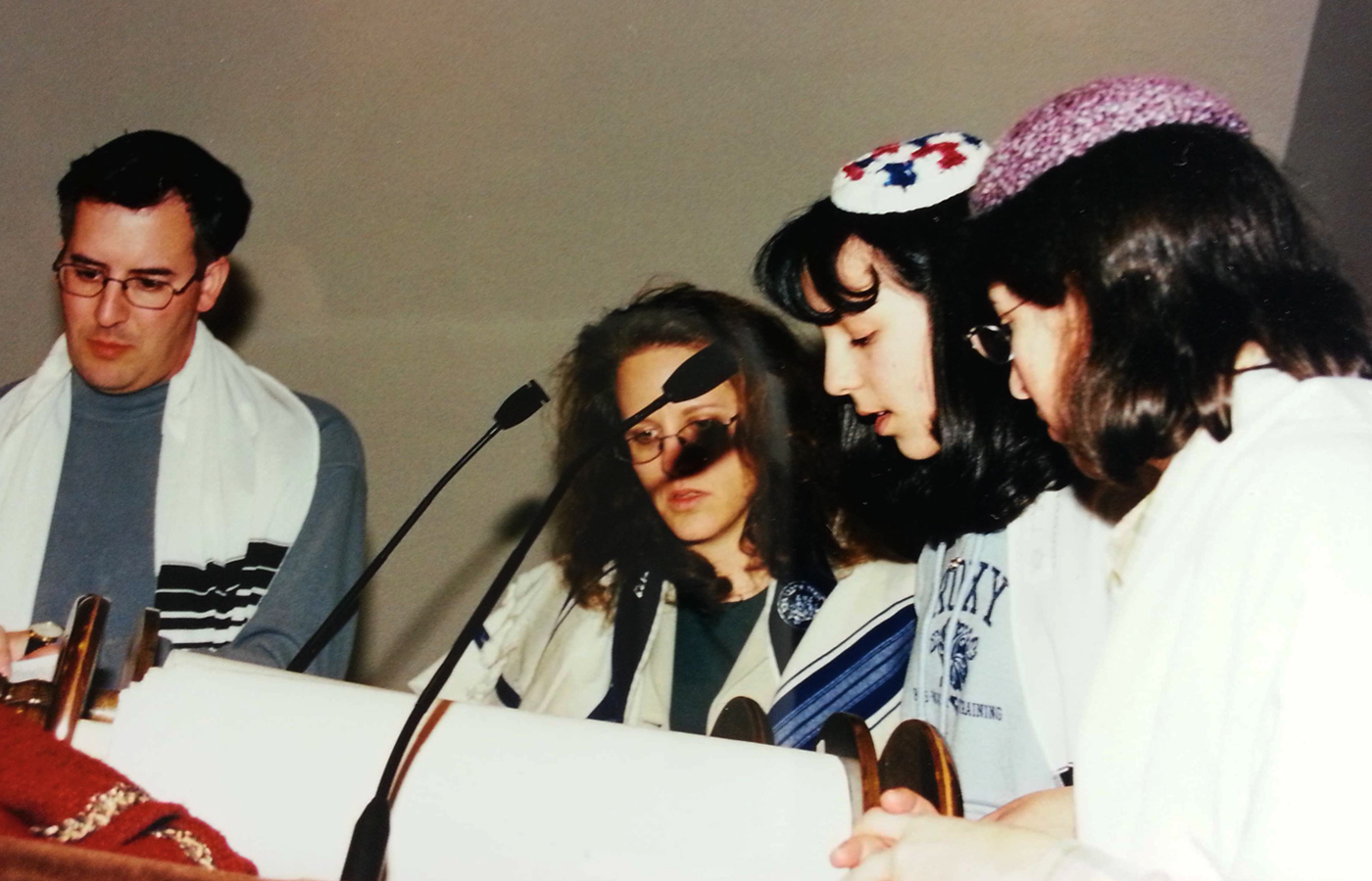 Me reading my Haftorah portion during a Bat-Mitzvah rehearsal with my aunt, uncle and cantor looking on. 