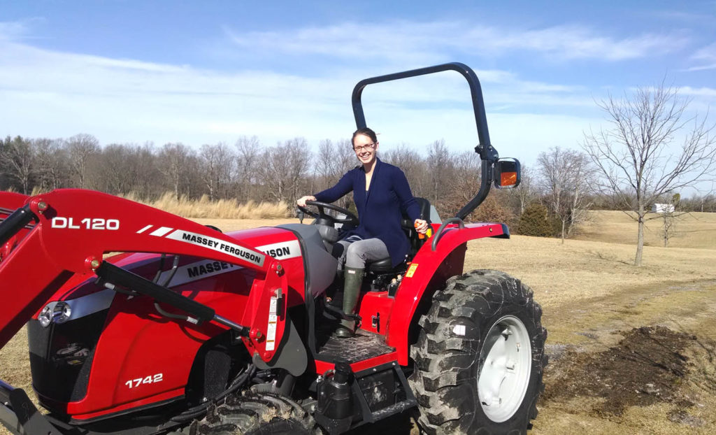 Young woman on a red tractor