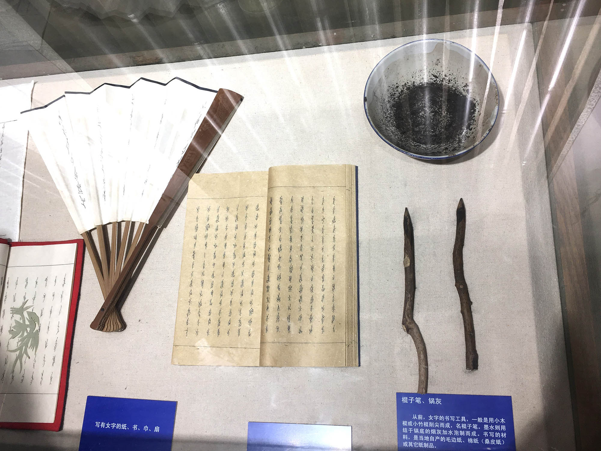 Nüshu writing tools: wood sticks, paper, wok pan ash and fan