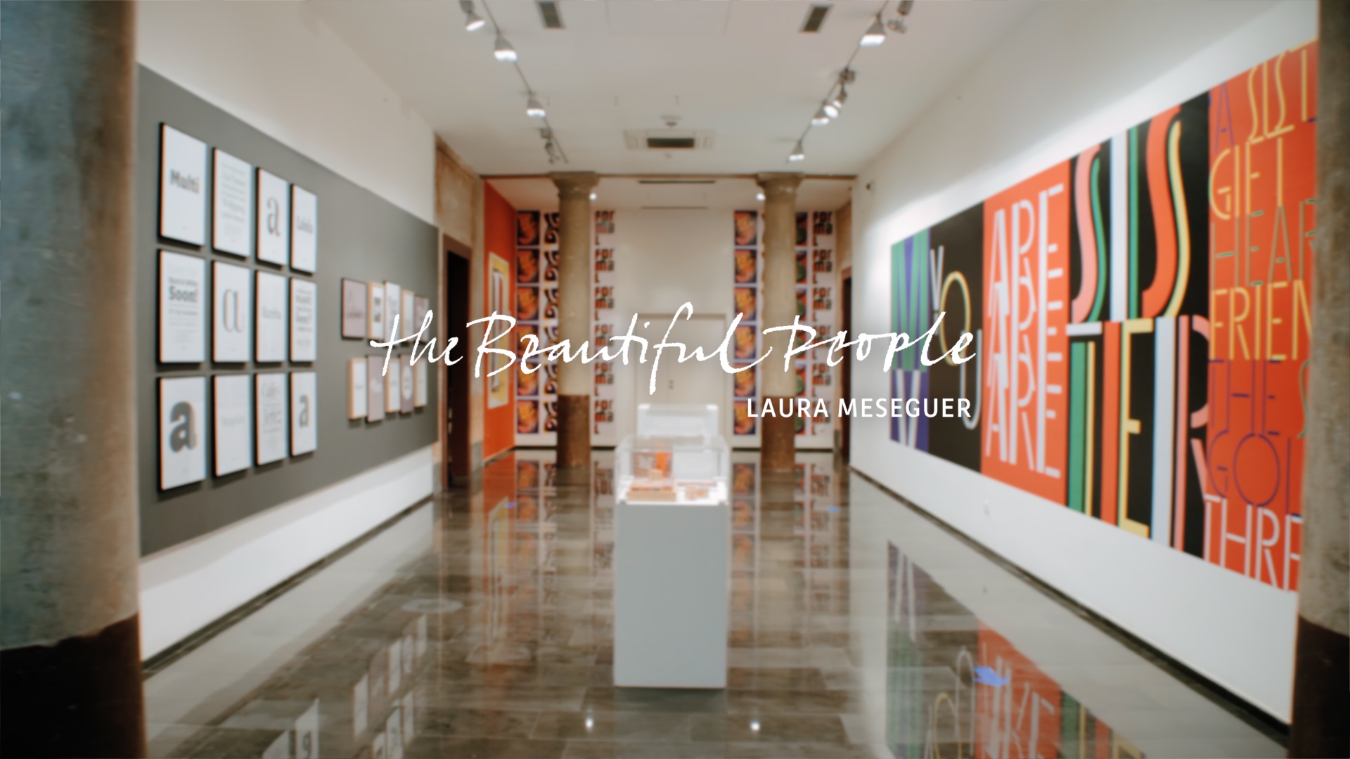 hallway of an exhibition with posters and artwork